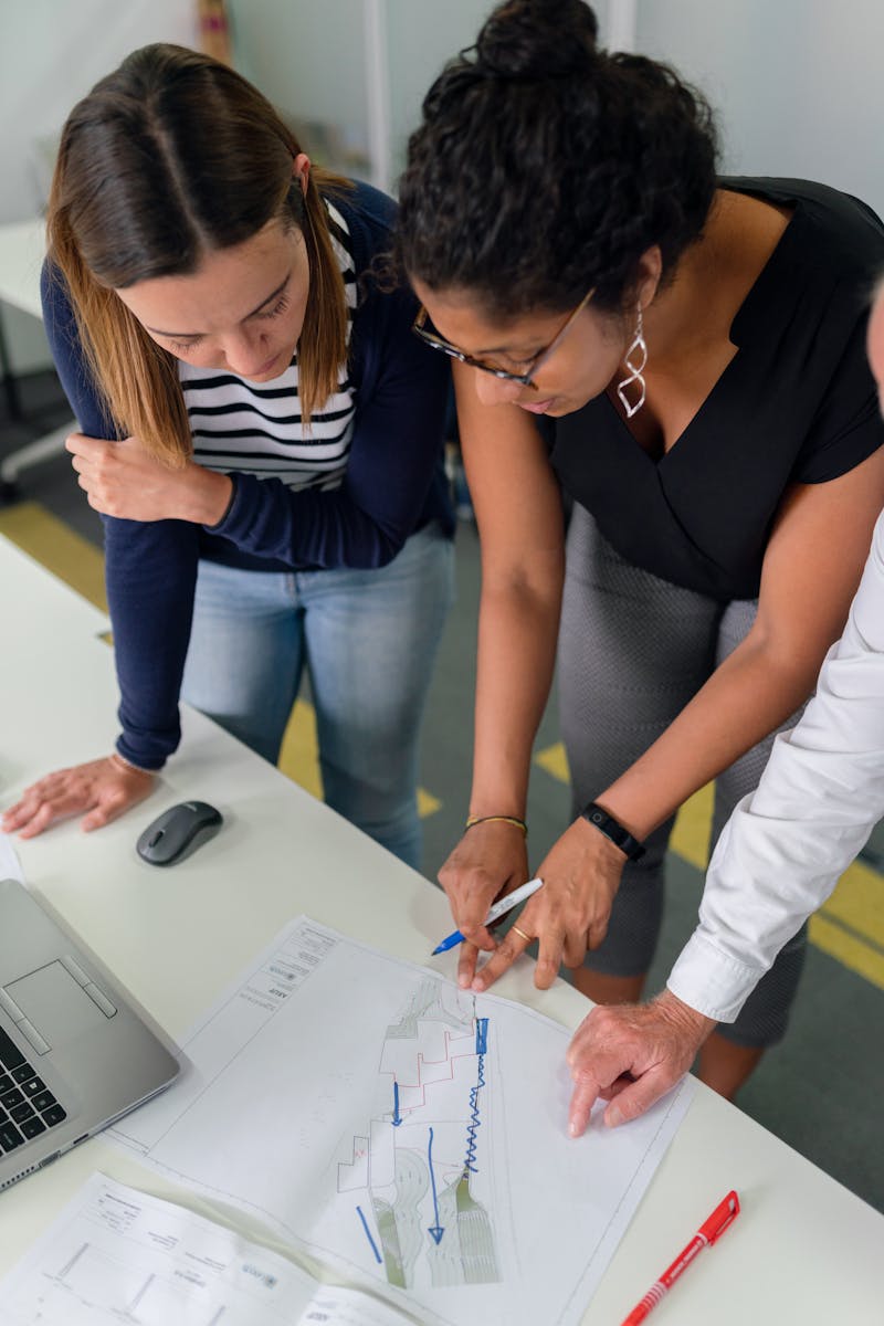 Team members engaged in collaborative planning at an office desk.